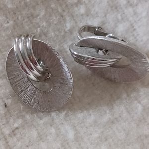 One pair of ladies silver tone clip on earrings made by Trifari